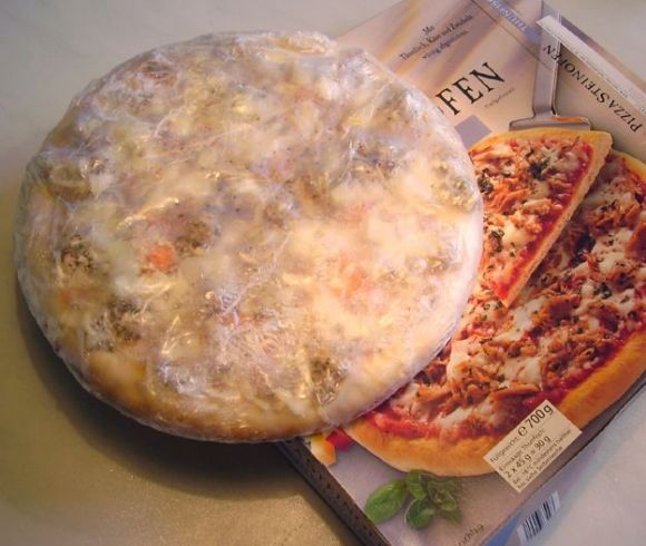 Frozen pizza, including transport cardboard box below teh frozen pizza. Frozen pizza, including transport cardboard box below teh frozen pizza.