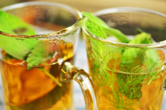 Two glasses of mint tea from fresh leaves. Tastes great and promotes good health. Two glasses of mint tea from fresh leaves. Tastes great and promotes good health.