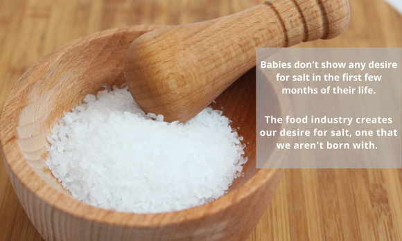 Salt in wooden mortar with its wooden pestle above the salt. Collage with text. Salt in wooden mortar with its wooden pestle above the salt. Collage with text.