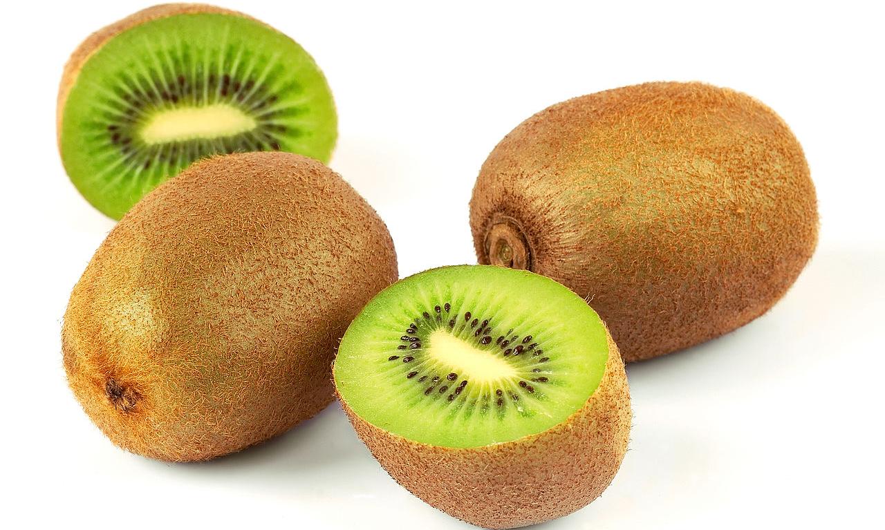Three kiwifruit, green, raw, one sliced, green pulp - yellow ones are sweeter. Three kiwifruit, green, raw, one sliced, green pulp - yellow ones are sweeter.