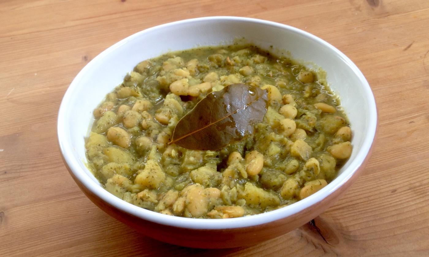 The finished potato and bean stew with dill served in a bowl