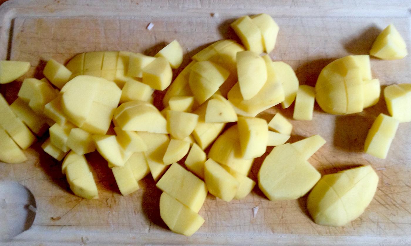 Chopped potato pieces for the potato and bean stew with dill