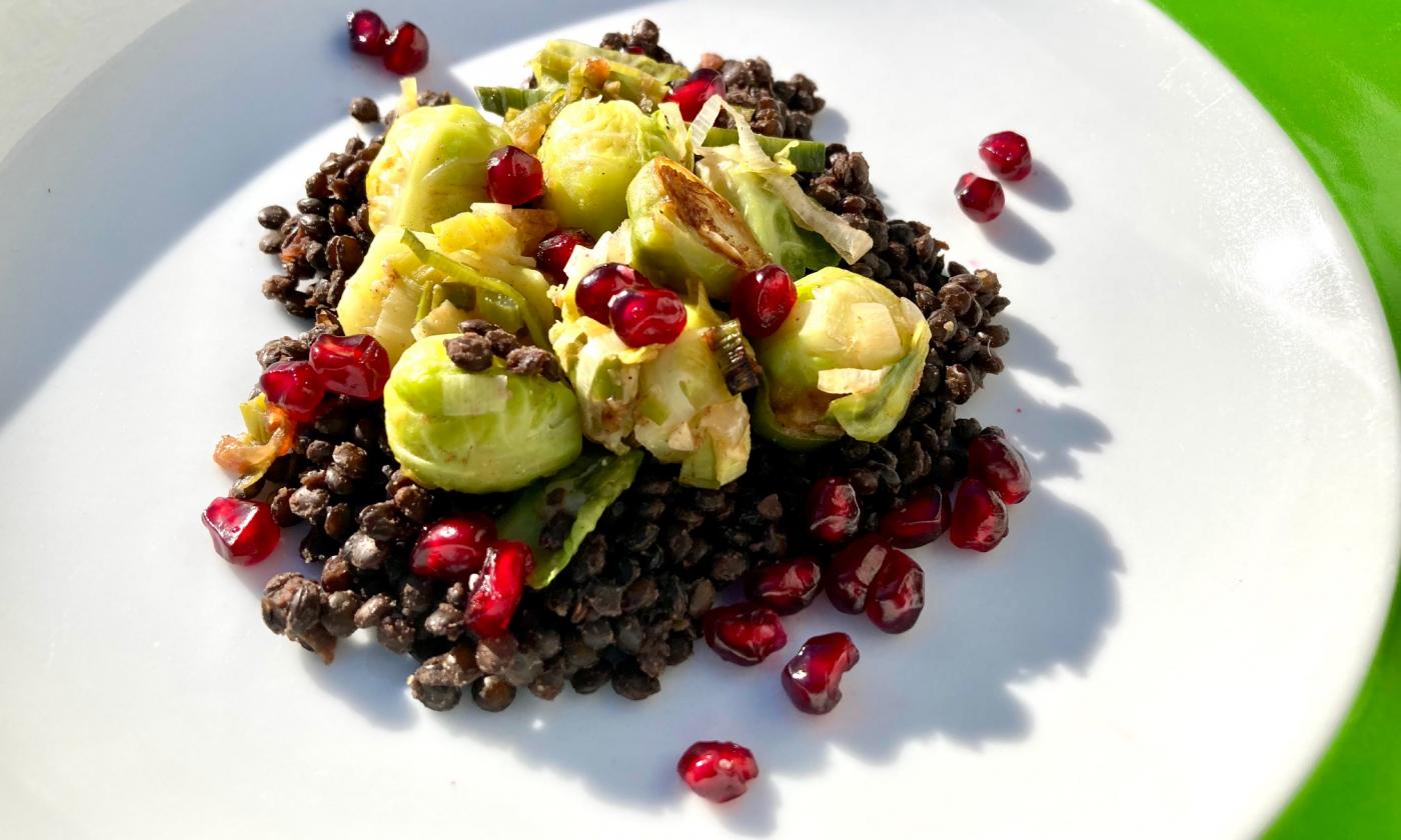 Imagen de la receta de las “coles de Bruselas orientales con lentejas y granada” preparadas.