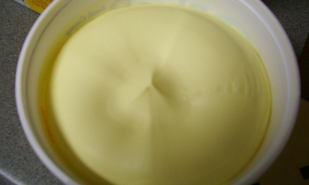 Purchased vegan vegetable margarine, without trans-fatty acids in a round package, opened. Purchased vegan vegetable margarine, without trans-fatty acids in a round package, opened.