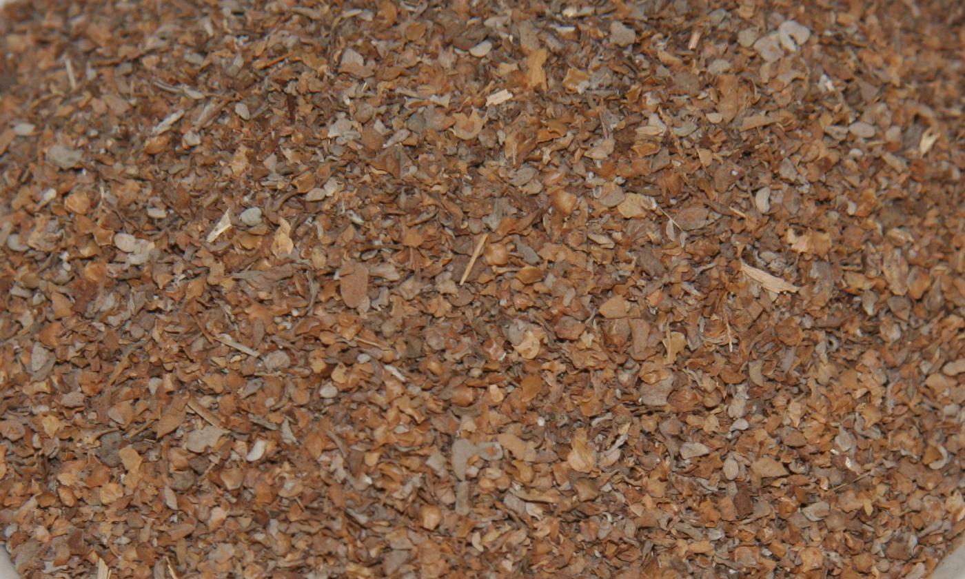 Dried marjoram (Origanum majorana) spread out on a plane surface.