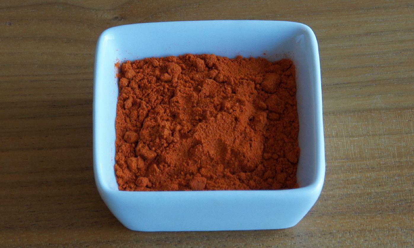 Ground paprika in a bowl. Ground paprika is available in various degrees of spiciness. Ground paprika in a bowl. Ground paprika is available in various degrees of spiciness.