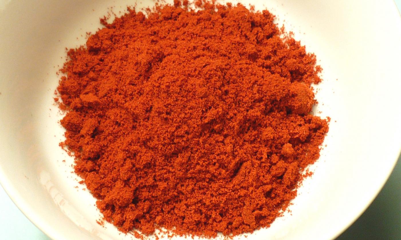 Ground paprika—Capsicum annuum: smoked ground Spanish paprika (pimentón) in a bowl. Ground paprika—Capsicum annuum: smoked ground Spanish paprika (pimentón) in a bowl.