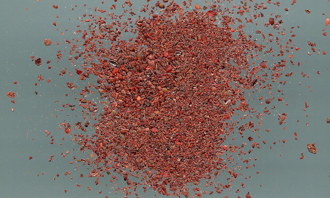 Spice mixture of Gerber Sumac (Rhus coriaria) on greyish-blue background. Spice mixture of Gerber Sumac (Rhus coriaria) on greyish-blue background.