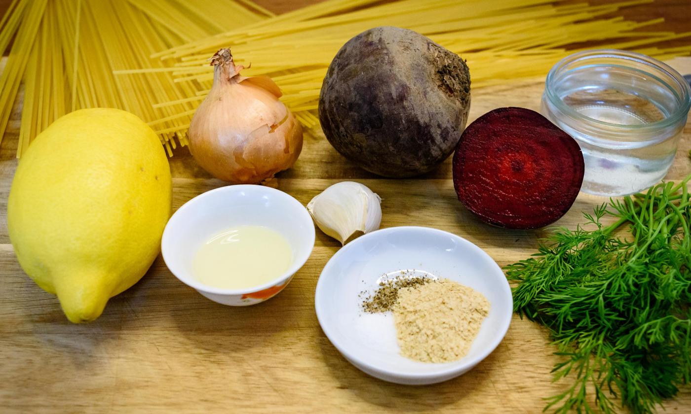 Prepared ingredients for the "beetroot pasta sauce" on a wooden table.