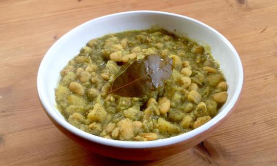 The finished potato and bean stew with dill served in a bowl