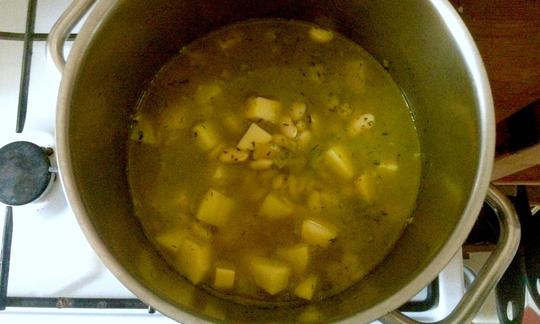 The finished potato and bean stew with dill in the pot