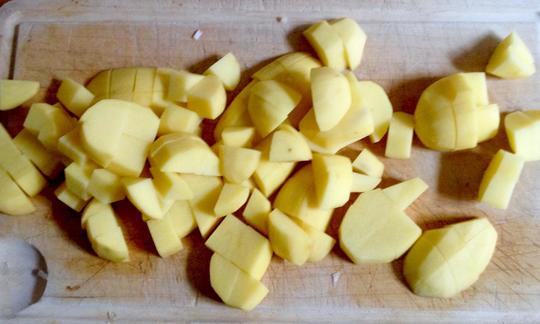 Chopped potato pieces for the potato and bean stew with dill