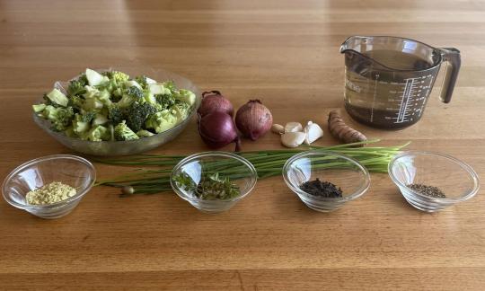 The mis-en-place for the broccoli soup with wakame flakes on a wooden table.
