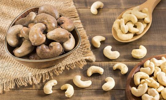 Cashew nut, dry, not salted - Anacardium occidentale, unpeeled in shell, peeled next to it. Cashew nut, dry, not salted - Anacardium occidentale, unpeeled in shell, peeled next to it.