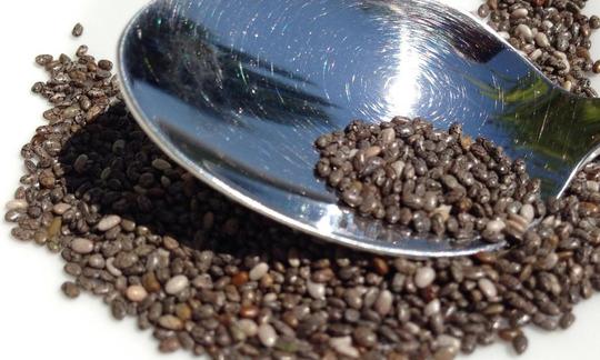Chia seeds in a spoon (Salvia hispanica) and spread out underneath. See also Salvia columbariae Chia seeds in a spoon (Salvia hispanica) and spread out underneath. See also Salvia columbariae