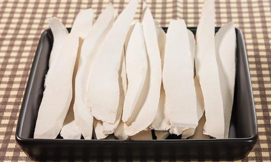 Chinese yam (raw edible), cut and dried in black bowl.