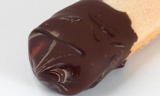 Ladyfinger partially dipped in dark couverture chocolate. Ladyfinger partially dipped in dark couverture chocolate.