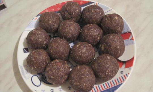 Date and Walnut Balls ready to eat, arranged on a plate.