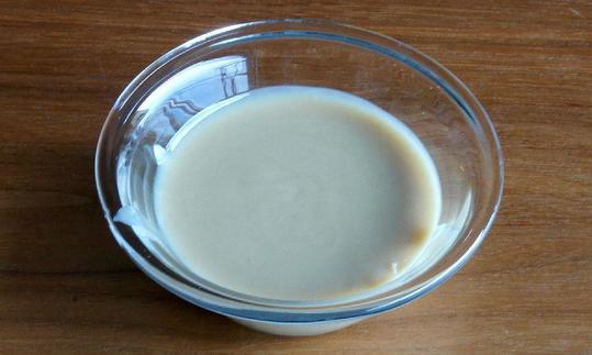 White almond butter in a bowl. Compared to the darker variety, white almond butter has a finer consistency and a milder flavor. Bright almond purée in a bowl: It has a finer texture and a slightly milder flavor than brown one.