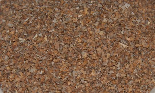 Dried marjoram (Origanum majorana) spread out on a plane surface.