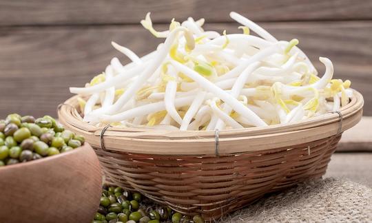 Mung bean sprouts, raw - Vigna radiata: basket full, with mung beans to the left.