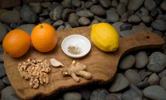 Ingredients for the "Oil-free salad dressing with walnuts and orange juice" on a cutting board.