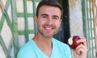 Apple, with peel (Malus domestica), a healthy man enjoying an apple (Malus domestica).