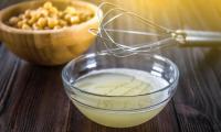 Aquafaba: the soaking or cooking water of chickpeas (or legumes) – in a  glass bowl.