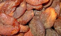 Dried and unsulphured peach fruits on a pile.