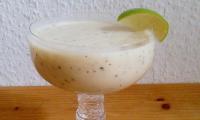 Velvety Smoothie, poured in a glass and garnished with a slice of lime, ready to serve
