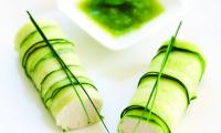 Cucumber Rolls with “Goat’s Cheese” and Mint Sauce on a white plate.