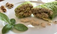 Ready-made "Savoy cabbage rolls filled with quinoa, cauliflower and walnuts", on a white plate.