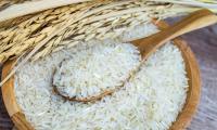 Jasmine rice from Thailand (Siam), also known as fragrant rice, in wooden bowl, above the ears.