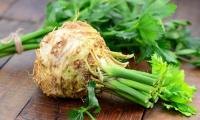 Celery, raw - Apium graveolens - washed and pre-cleaned on a wooden surface.