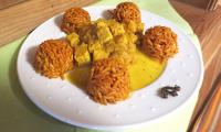 El «Tempeh a la naranja con curry y arroz especiado» terminado y servido en un plato.