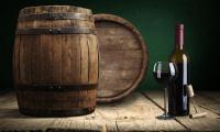 Port wine - Vitis vinifera - Port barrels on the left, with a bottle and glass of port to the right.