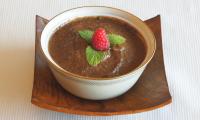 Chocolate cream with raw cocoa beans, avocado, dates, carob powder - finished in bowl.