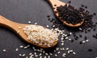 Sesame seeds, black, hulled in the foreground. Unhulled black (more nutrients) or light brown