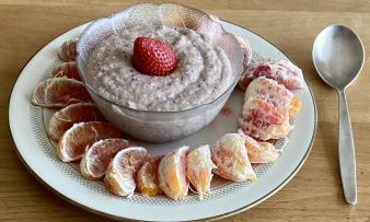Pea pudding with psyllium husks in a glass bowl, surrounded by blood orange slices in a plate. Pea pudding with psyllium husks in a glass bowl, surrounded by blood orange slices in a plate.